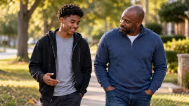 Stepdad building trust with his teenage stepson during a relaxed walk and conversation.